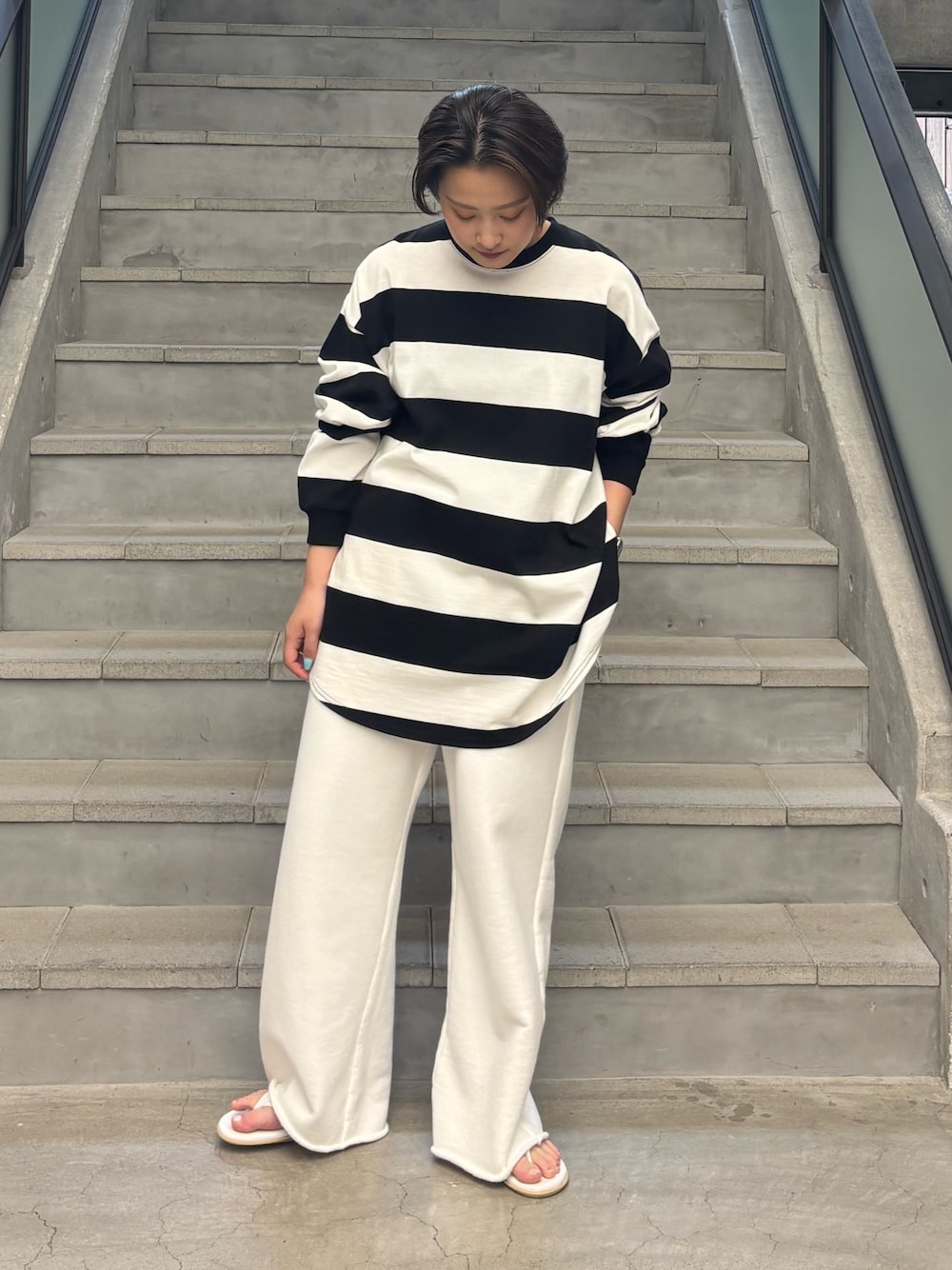 ブラック系のTシャツ/カットソー、ホワイト系のスウェットパンツを着用したレディースの夏コーディネートの1枚目の写真