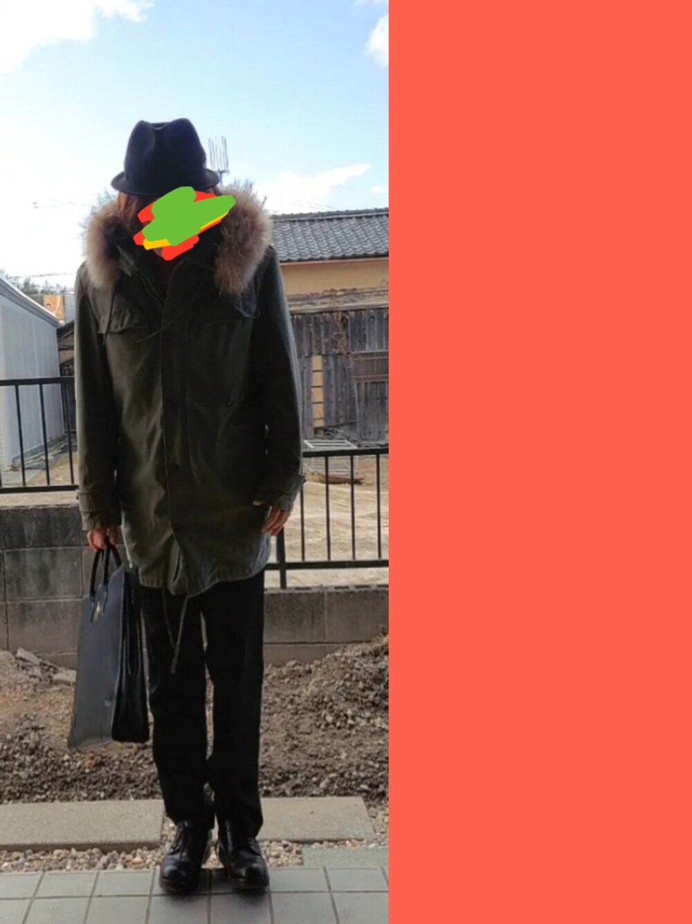 グリーン系のモッズコート、ブラック系のビジネスバッグ、ブラック系のスラックスを着用したメンズの冬コーディネートの2枚目の写真