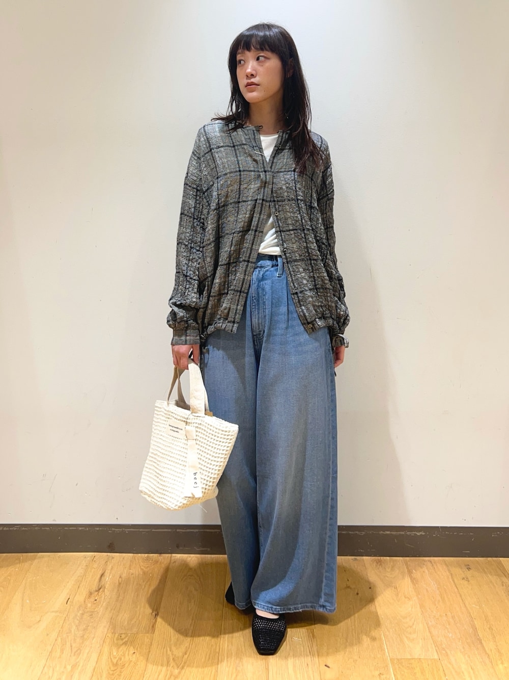 ブラック系のシャツ/ブラウス、ホワイト系のTシャツ/カットソー、ブルー系のデニムパンツを着用したレディースの春コーディネートの1枚目の写真