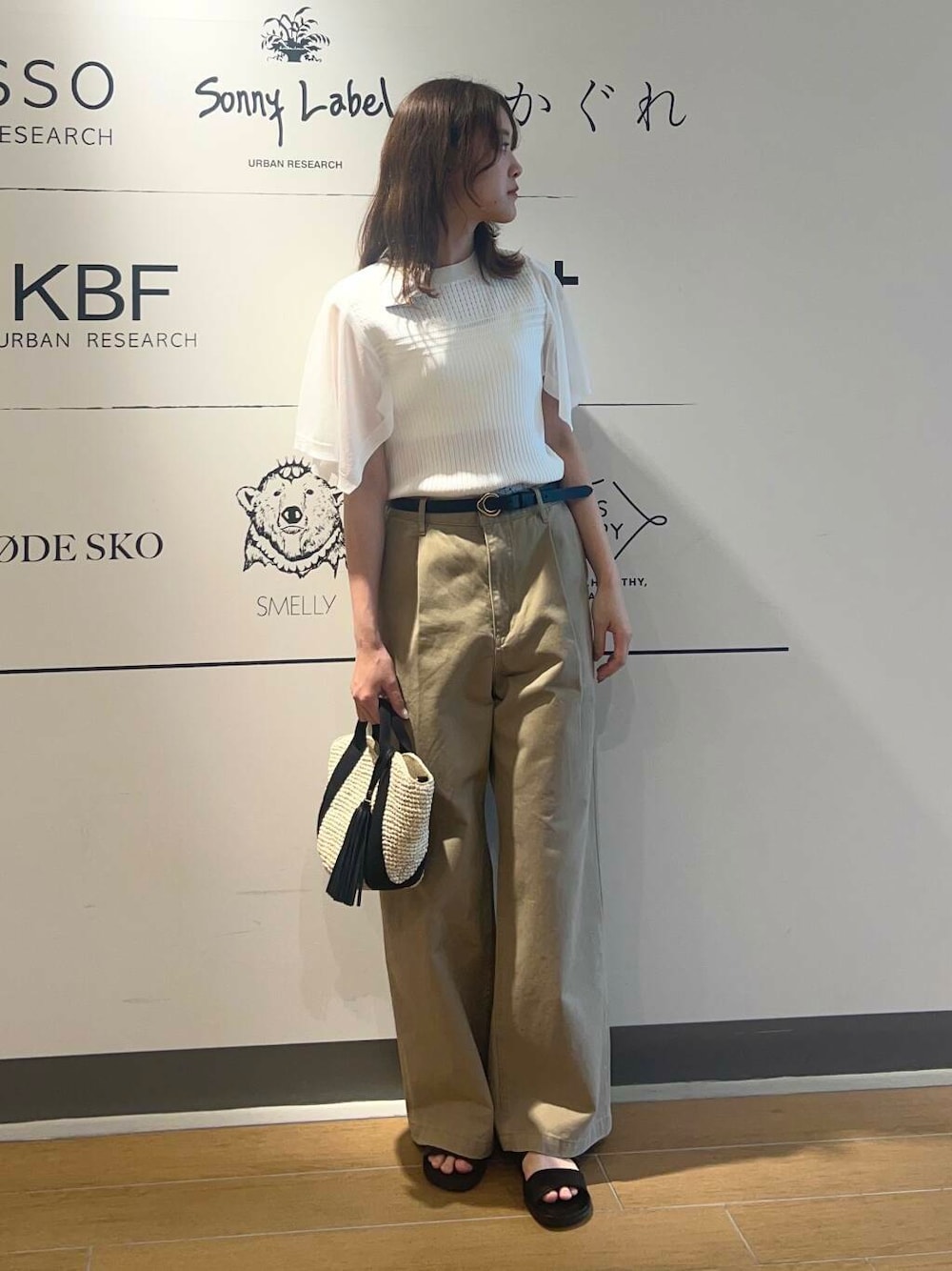 ベージュ系のかごバッグ、ベージュ系のその他パンツ、ブラック系のサンダルを着用したレディースの春コーディネートの1枚目の写真