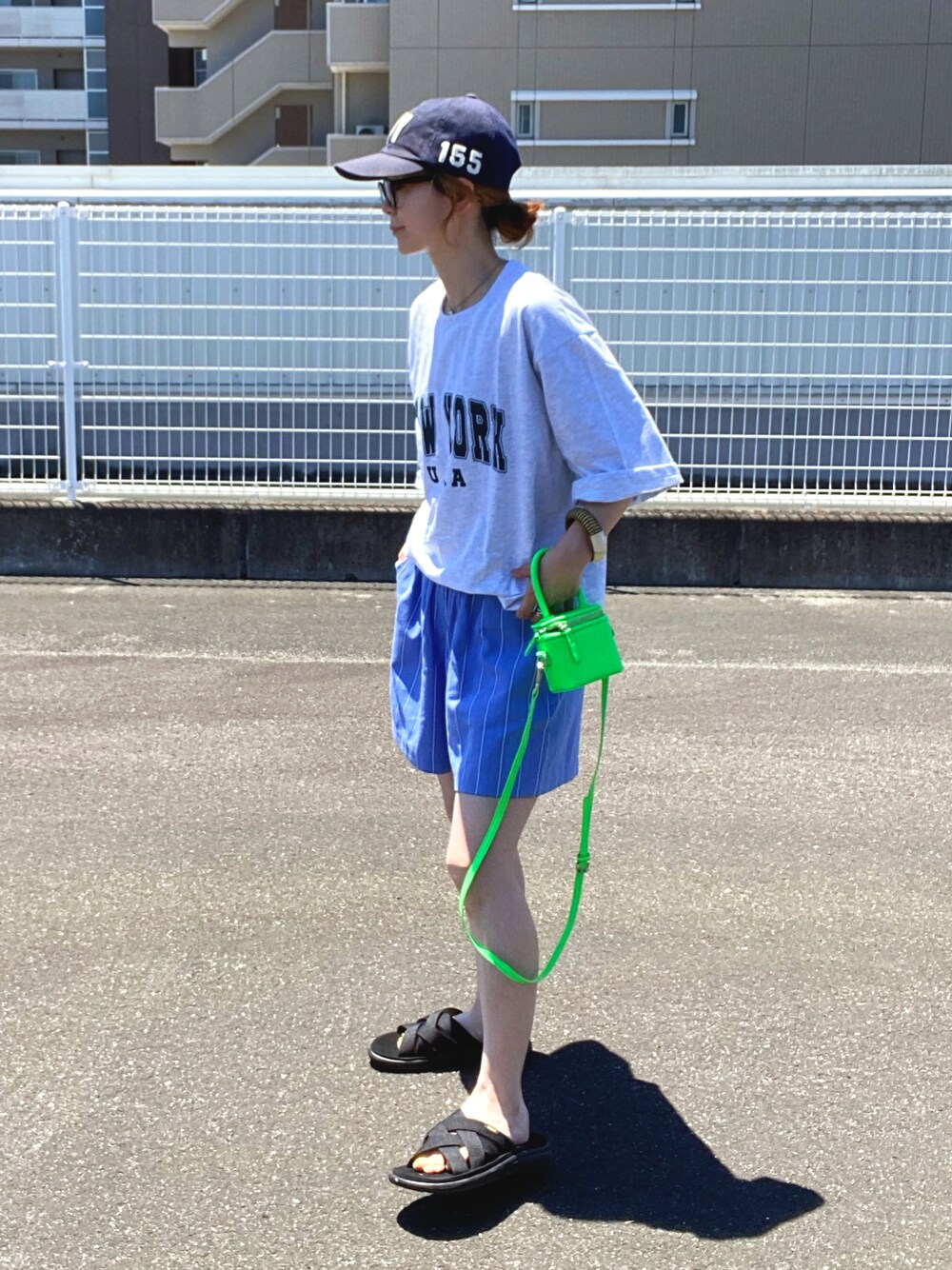 グレー系のTシャツ/カットソー、ブラック系のサンダルを着用したレディースの夏コーディネートの1枚目の写真
