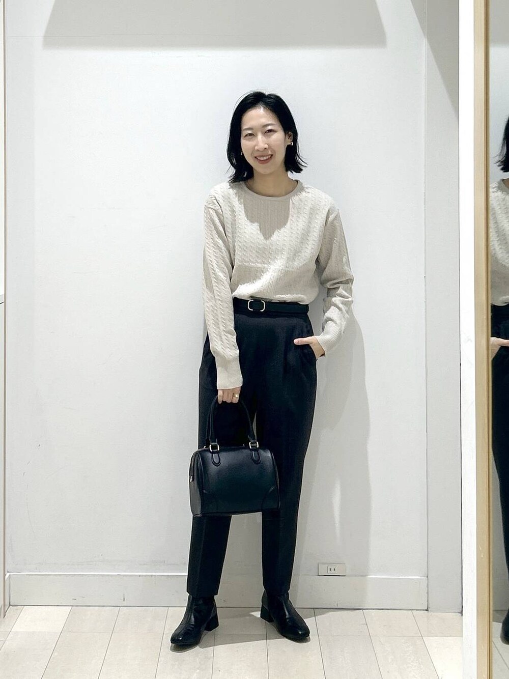 グレー系のその他パンツ、ブラック系のボストンバッグ、ブラック系のブーツを着用したレディースの冬コーディネートの1枚目の写真