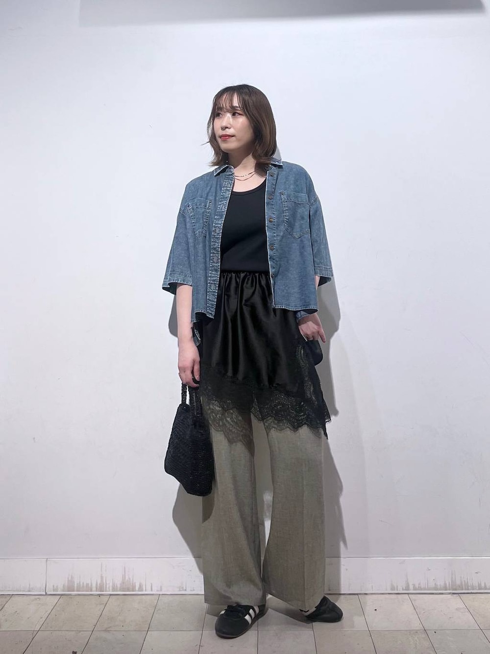 ベージュ系のその他パンツ、ブラック系のタンクトップ、ブラック系のその他トップスを着用したレディースの春コーディネートの1枚目の写真