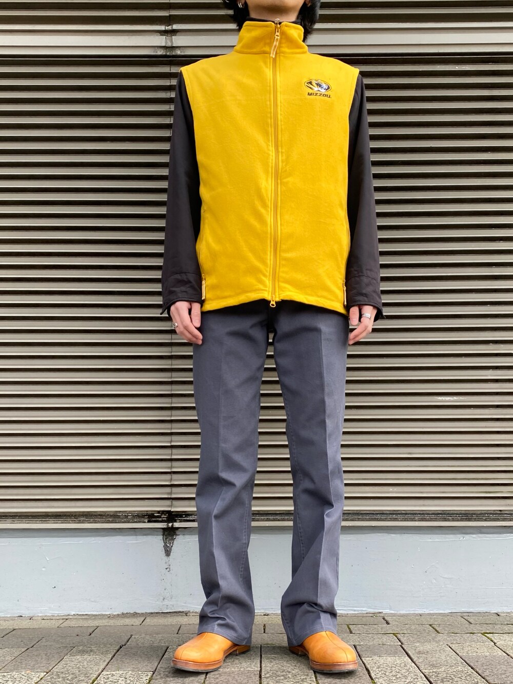 イエロー系のジャケット/アウター、ブラック系のジャケット/アウター、グレー系のパンツを着用したメンズの冬コーディネートの1枚目の写真