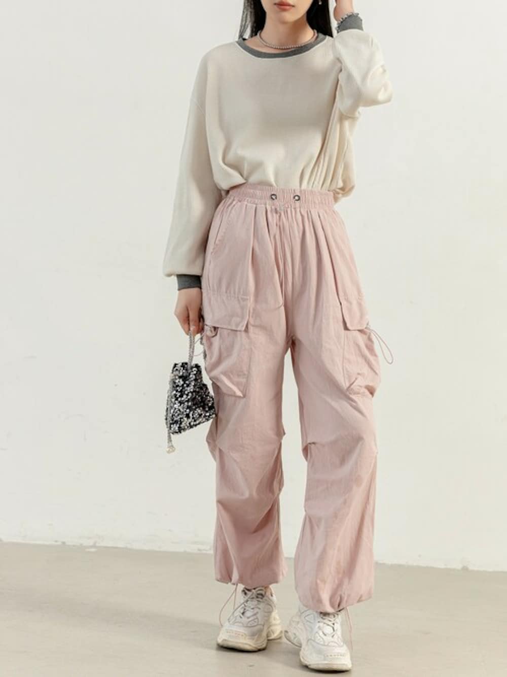 ピンク系のカーゴパンツ、ホワイト系のTシャツ/カットソーを着用したレディースの冬コーディネートの1枚目の写真