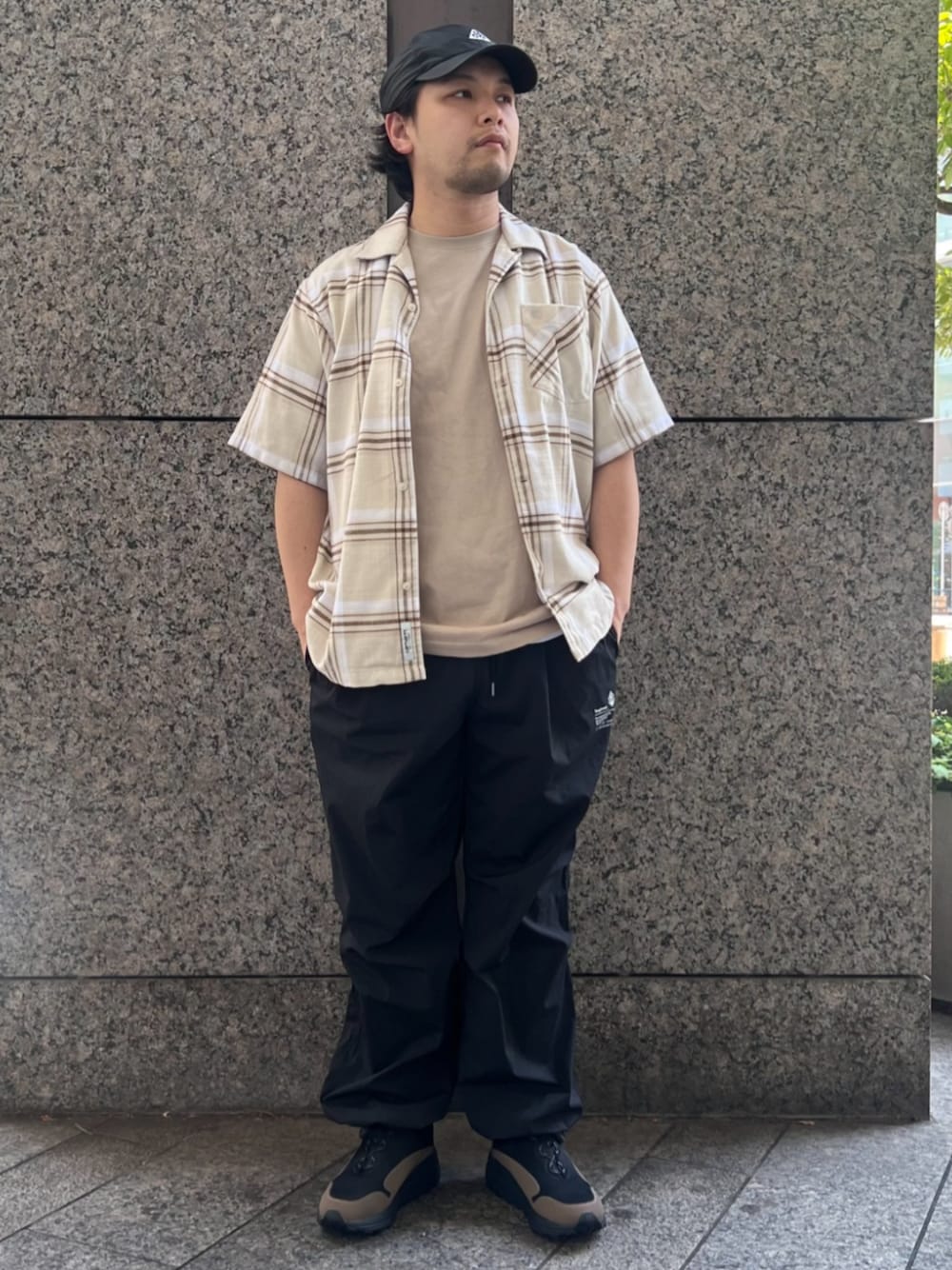 ブラック系のその他パンツ、ベージュ系のTシャツ/カットソー、ブラック系のスニーカーを着用したメンズの夏コーディネートの1枚目の写真