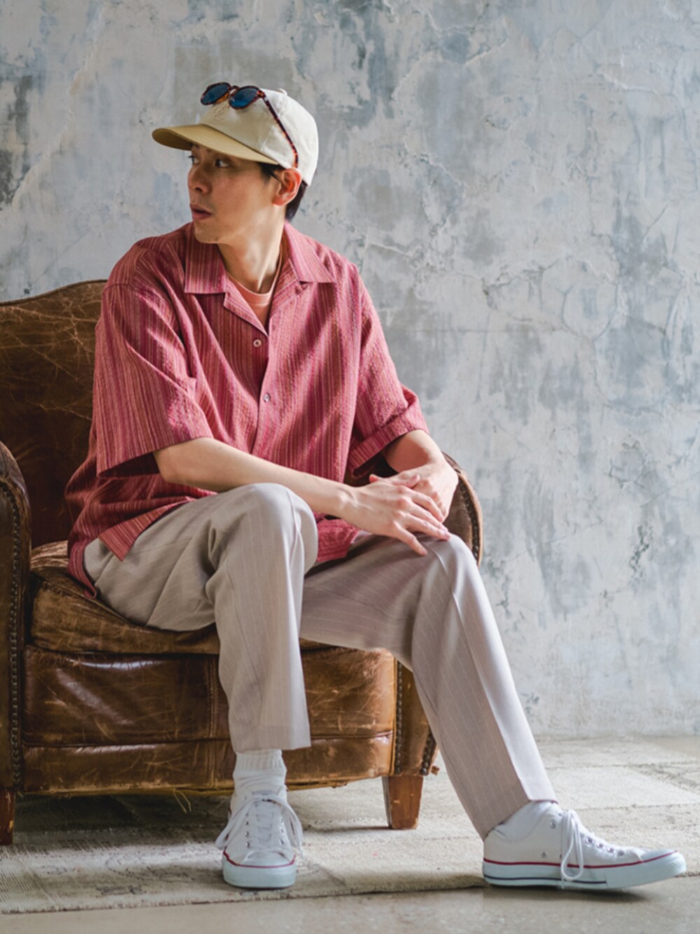 レッド系のシャツ/ブラウス、ピンク系のTシャツ/カットソー、ベージュ系のスラックスを着用したメンズの春コーディネートの1枚目の写真