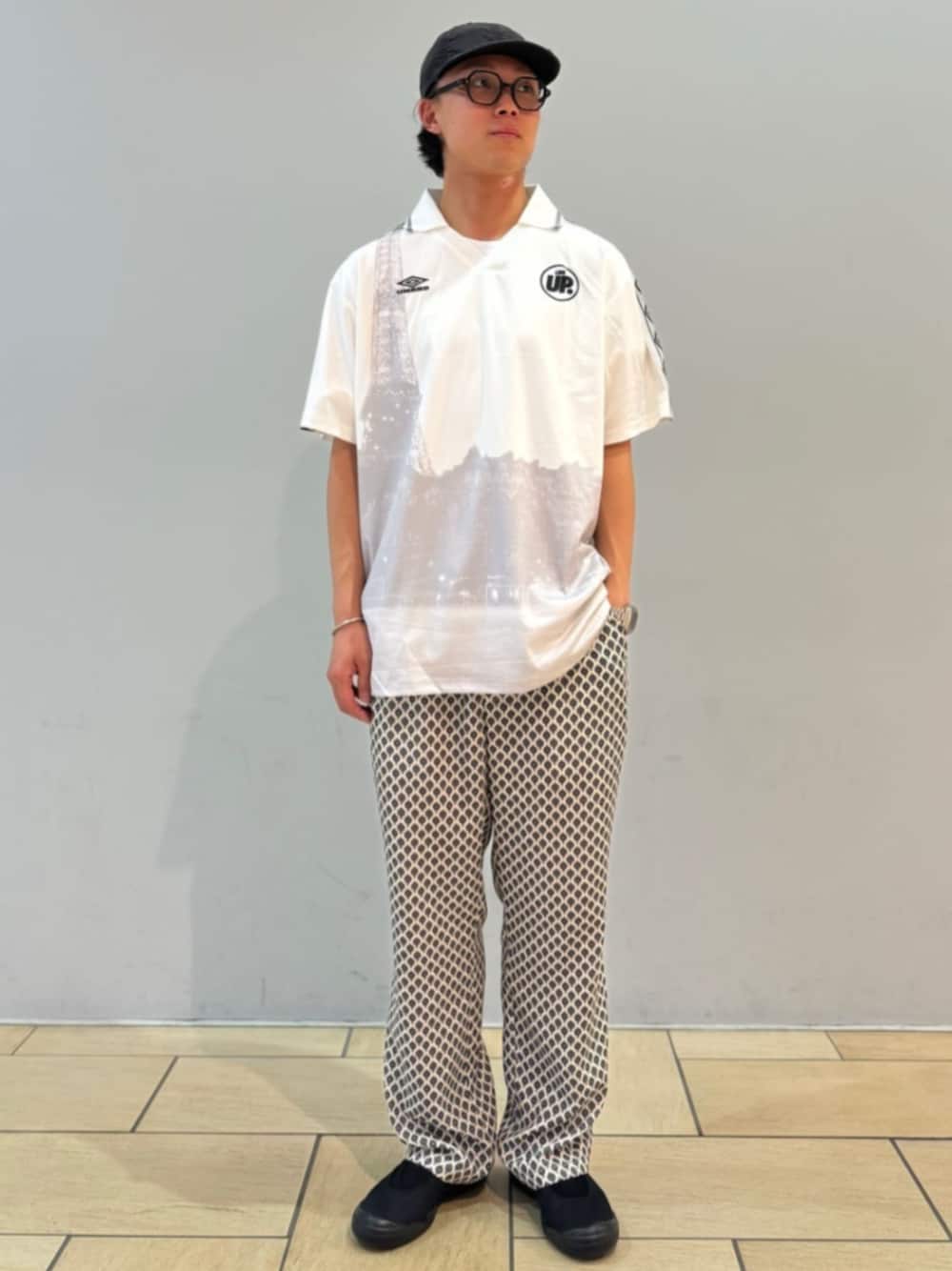 ブラック系のスニーカー、ホワイト系のTシャツ/カットソー、ホワイト系のスラックスを着用したメンズの夏コーディネートの1枚目の写真