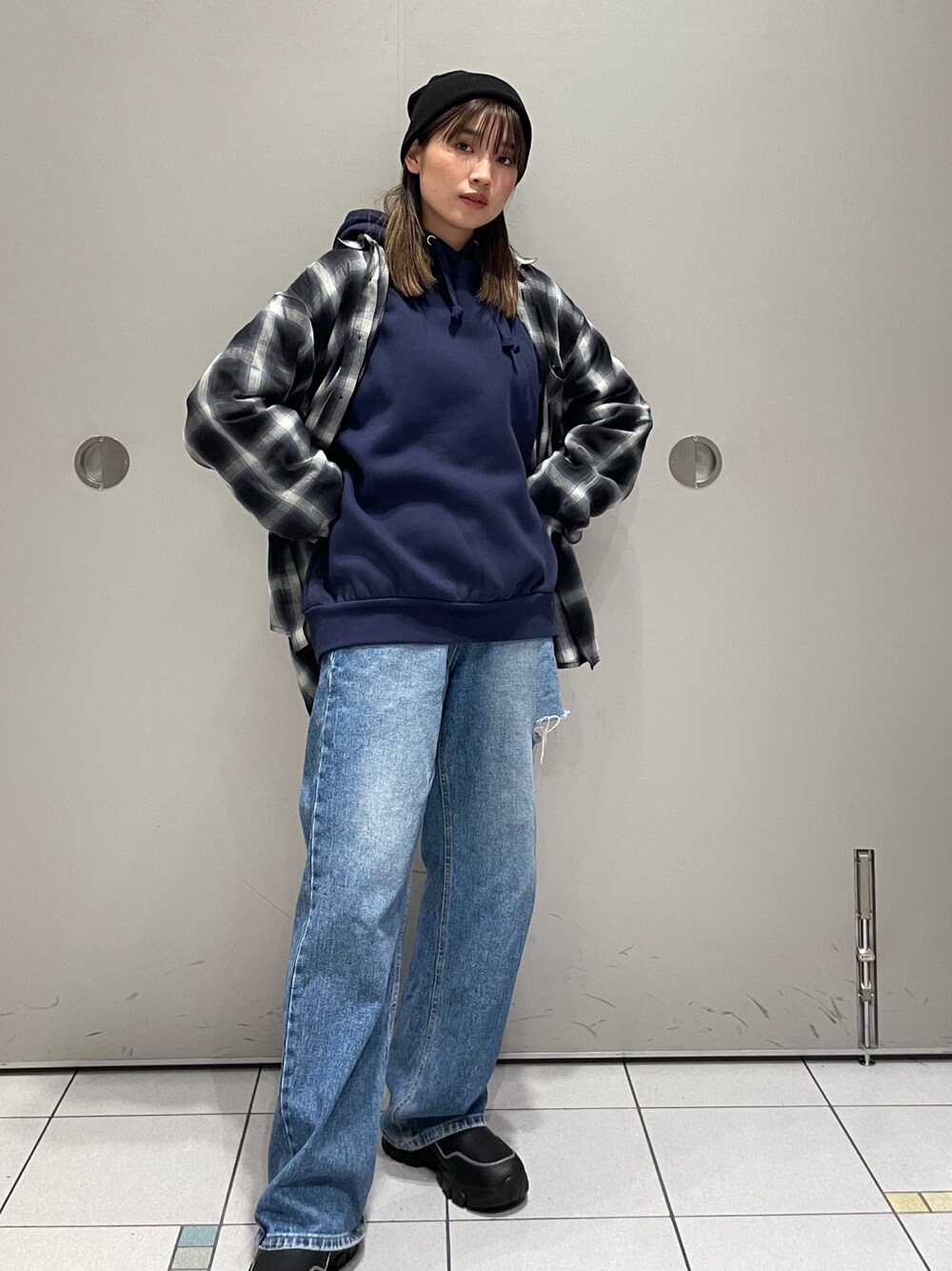 ブルー系のパーカー、ブラック系のブーツを着用したレディースの秋コーディネートの1枚目の写真