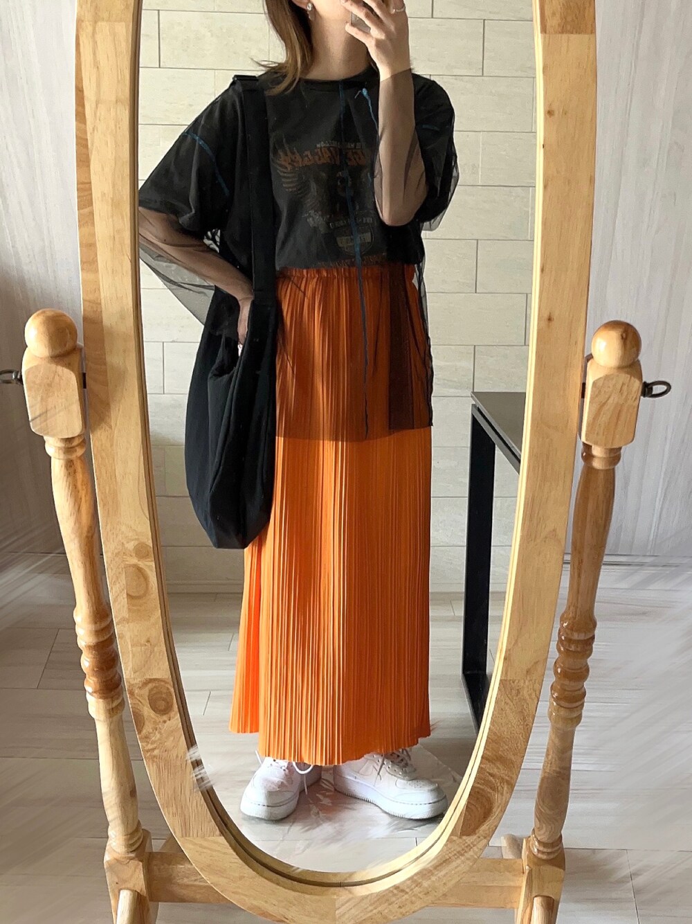 ホワイト系のスニーカー、オレンジ系のスカート、グレー系のTシャツ/カットソーを着用したレディースの夏コーディネートの1枚目の写真