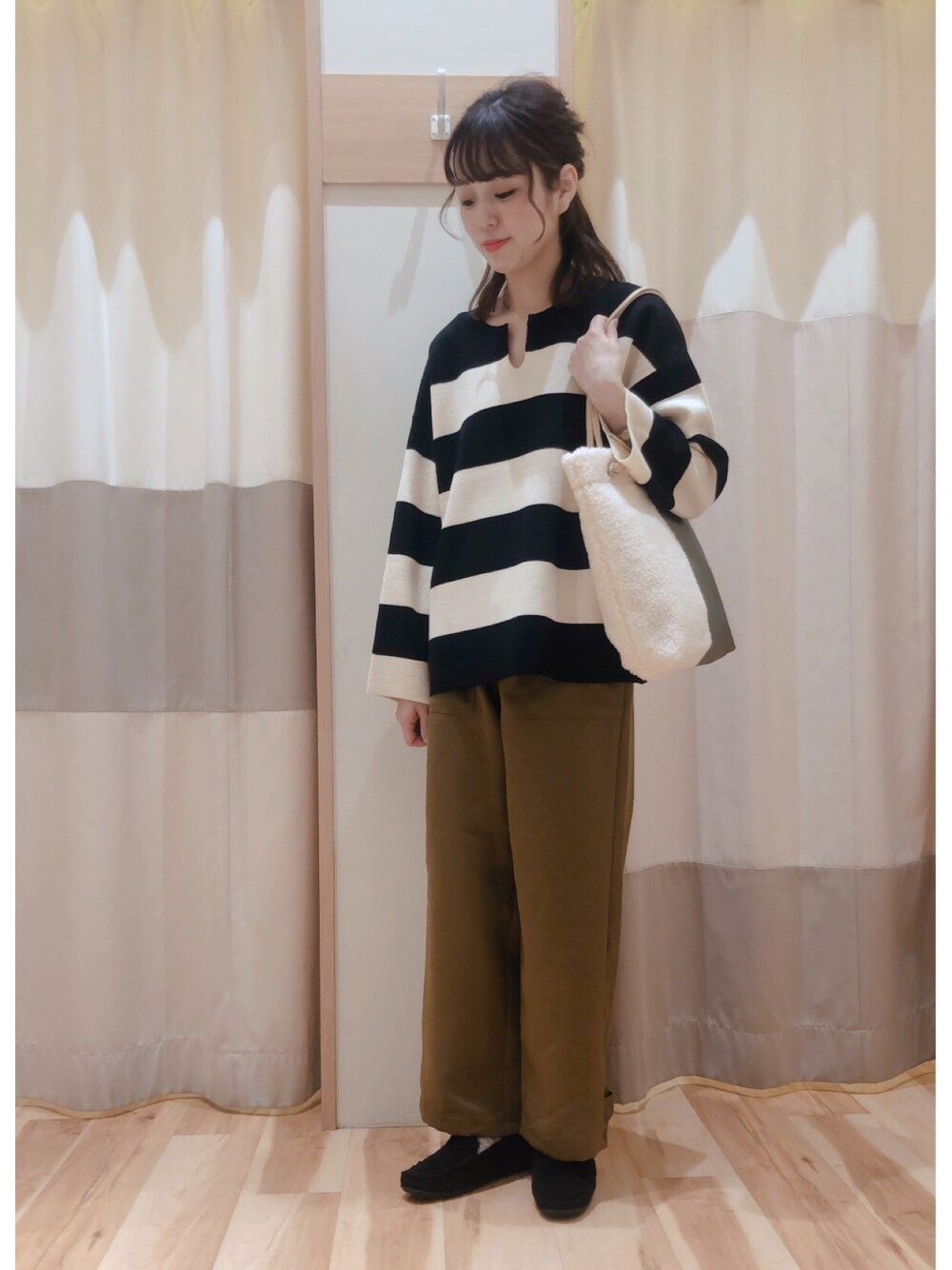 グリーン系のその他パンツ、ブラック系のニット/セーター、ブラック系のモカシン/デッキシューズを着用したレディースの秋コーディネートの1枚目の写真