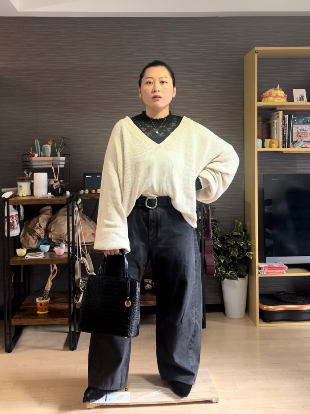 ホワイト系のニット/セーター、ブラック系のデニムパンツ、ブラック系のパンプスを着用したレディースの冬コーディネートの1枚目の写真