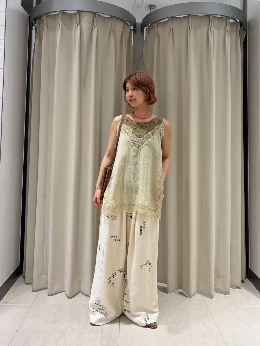 ベージュ系のキャミソール、ホワイト系のその他パンツ、イエロー系のショルダーバッグを着用したレディースの春コーディネートの1枚目の写真