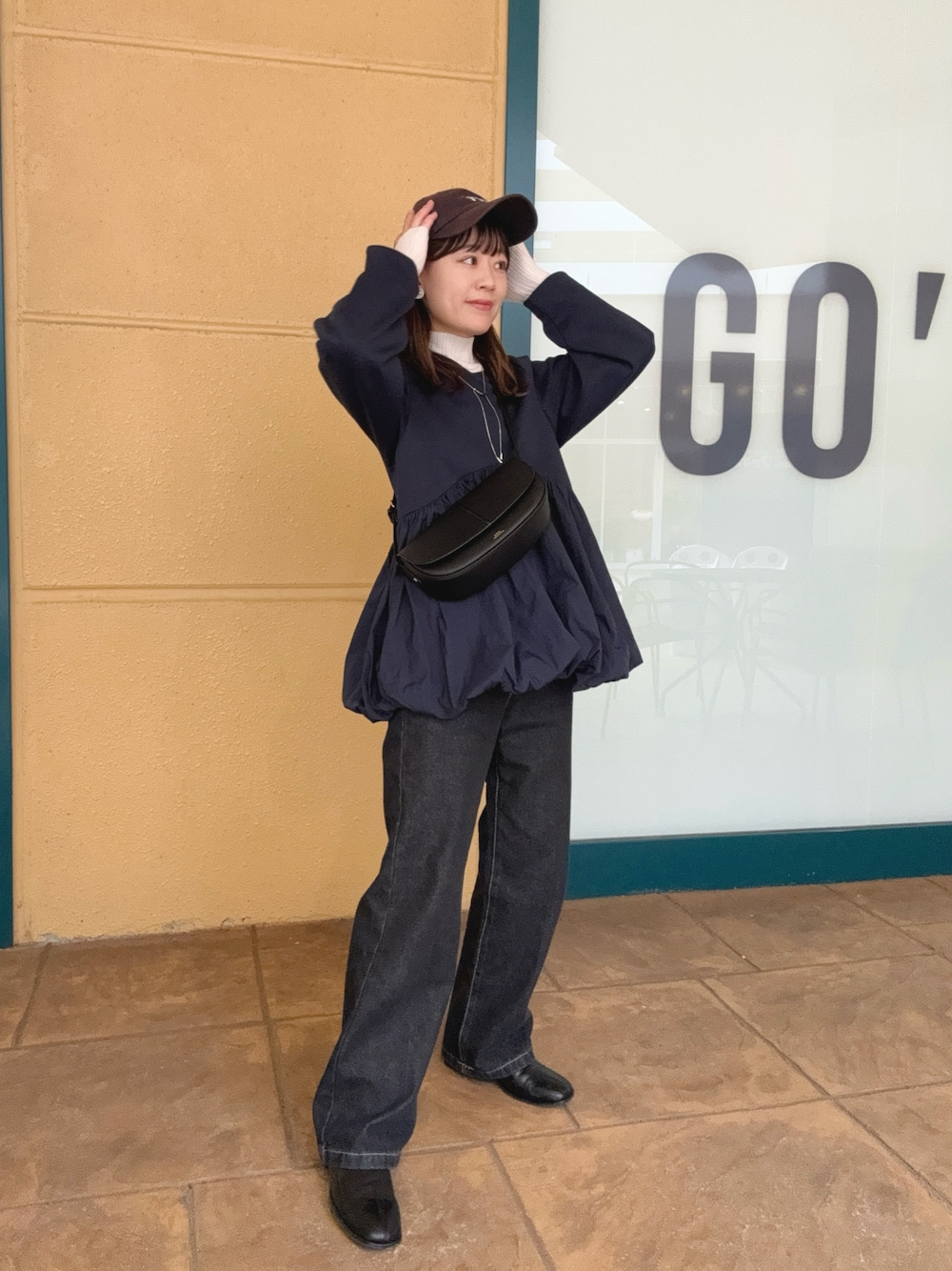 ブルー系のTシャツ/カットソー、ブラック系のデニムパンツ、ブラック系のショルダーバッグを着用したレディースの秋コーディネートの1枚目の写真