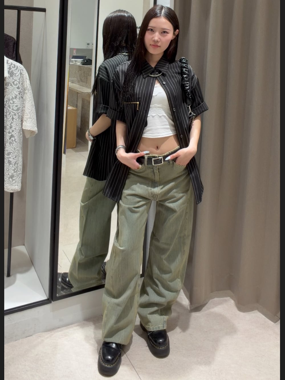 ブラック系のシャツ/ブラウス、グリーン系のデニムパンツ、ブラック系のショルダーバッグを着用したレディースの春コーディネートの1枚目の写真