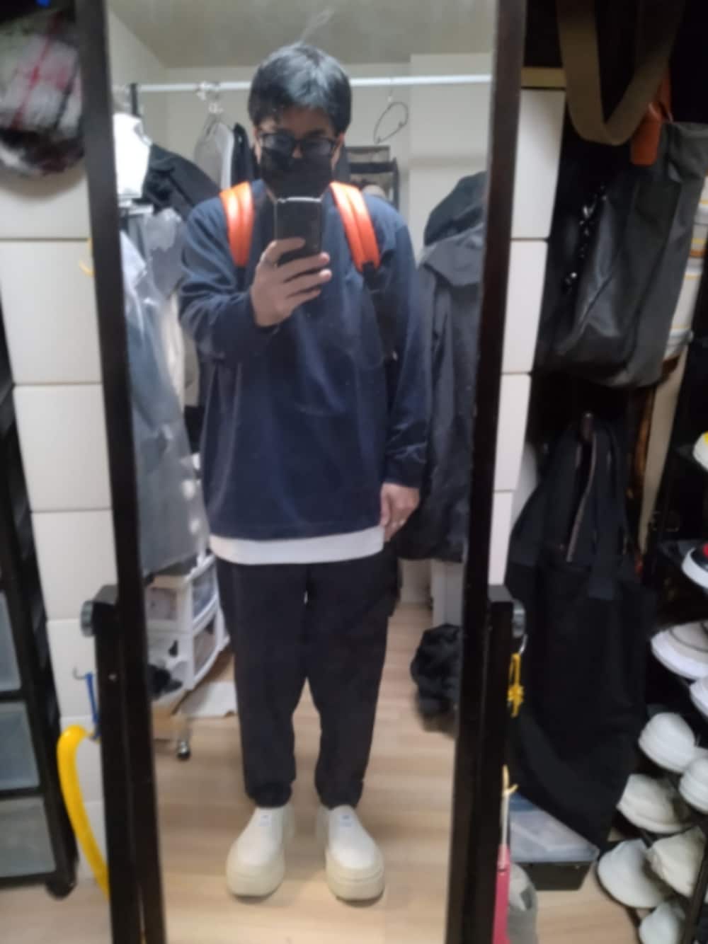 ホワイト系のスニーカー、ブルー系のスラックス、ブルー系のTシャツ/カットソーを着用したメンズの秋コーディネートの1枚目の写真