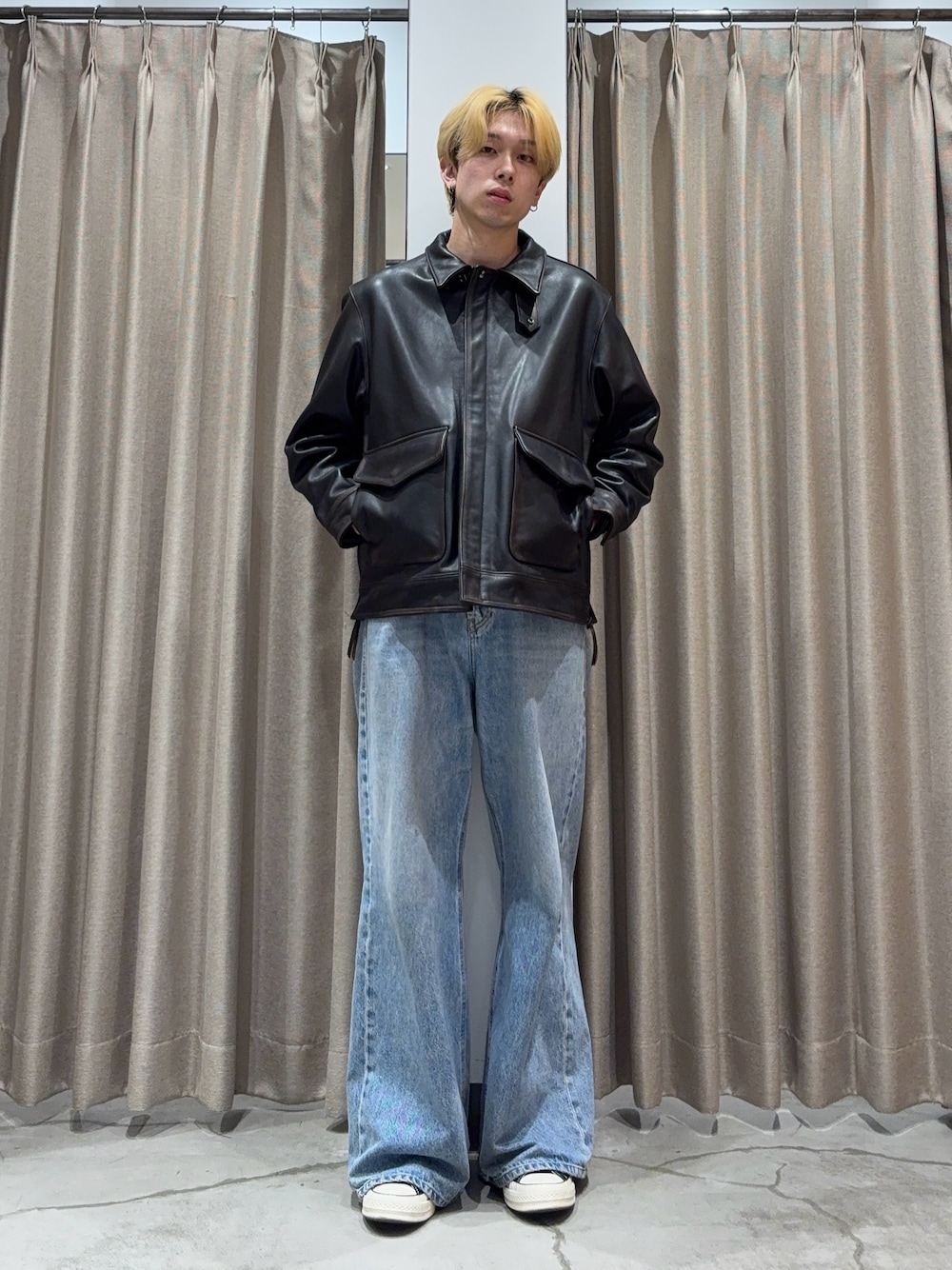 ブラック系のその他アウター、ブルー系のデニムパンツ、ブラック系のスニーカーを着用したメンズの秋コーディネートの1枚目の写真