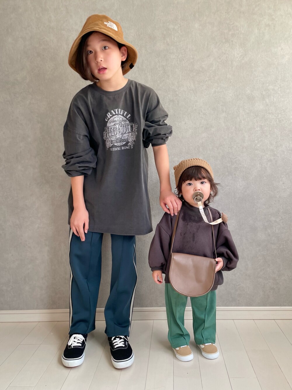ブラック系のTシャツ/カットソー、グリーン系のその他パンツ、グリーン系のスラックスを着用したキッズの秋コーディネートの1枚目の写真
