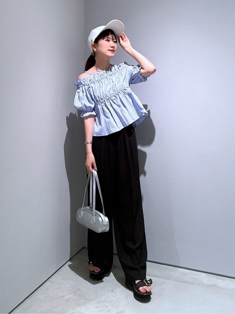 ブルー系のシャツ/ブラウス、ブラック系のその他パンツ、シルバー系のハンドバッグを着用したレディースの夏コーディネートの1枚目の写真