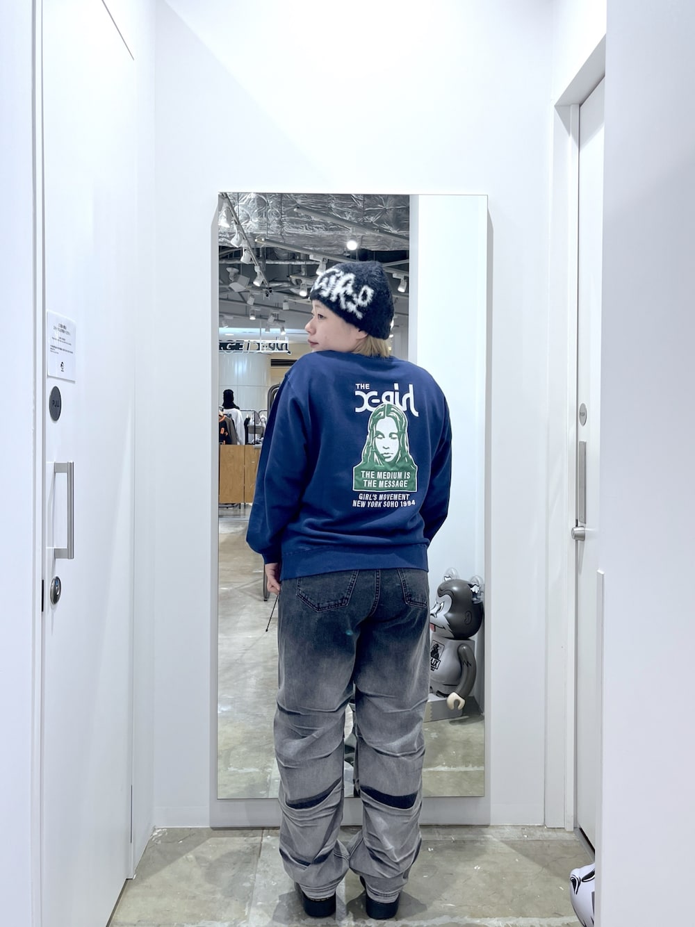 ブルー系のスウェット、ブラック系のデニムパンツ、ブラック系のニットキャップ/ビーニーを着用したレディースの冬コーディネートの1枚目の写真