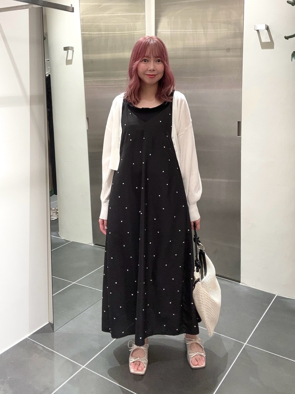 ブラック系のワンピース、ホワイト系のカーディガン/ボレロ、ブラック系のタンクトップを着用したレディースの夏コーディネートの1枚目の写真