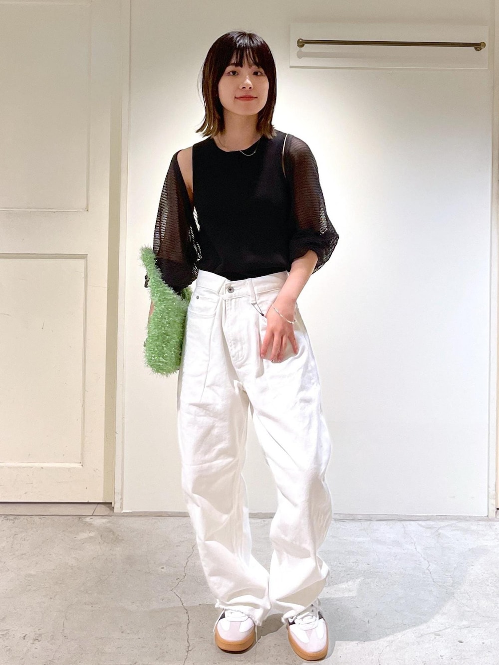 グレー系のカーディガン/ボレロ、グリーン系のハンドバッグ、ホワイト系のデニムパンツを着用したレディースの夏コーディネートの1枚目の写真