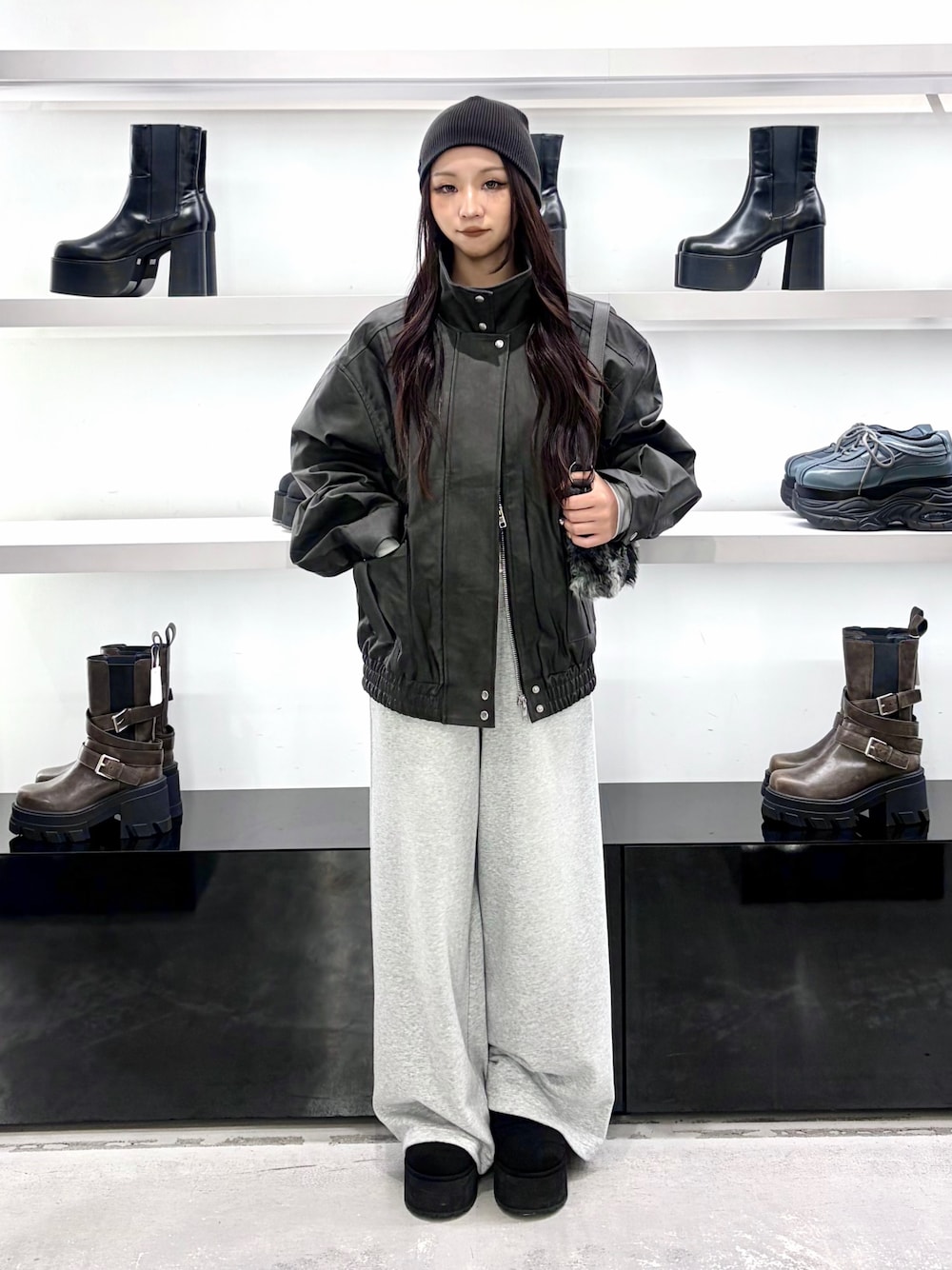 ブラック系のブルゾン、ブラック系のショルダーバッグ、グレー系のその他パンツを着用したレディースの秋コーディネートの1枚目の写真