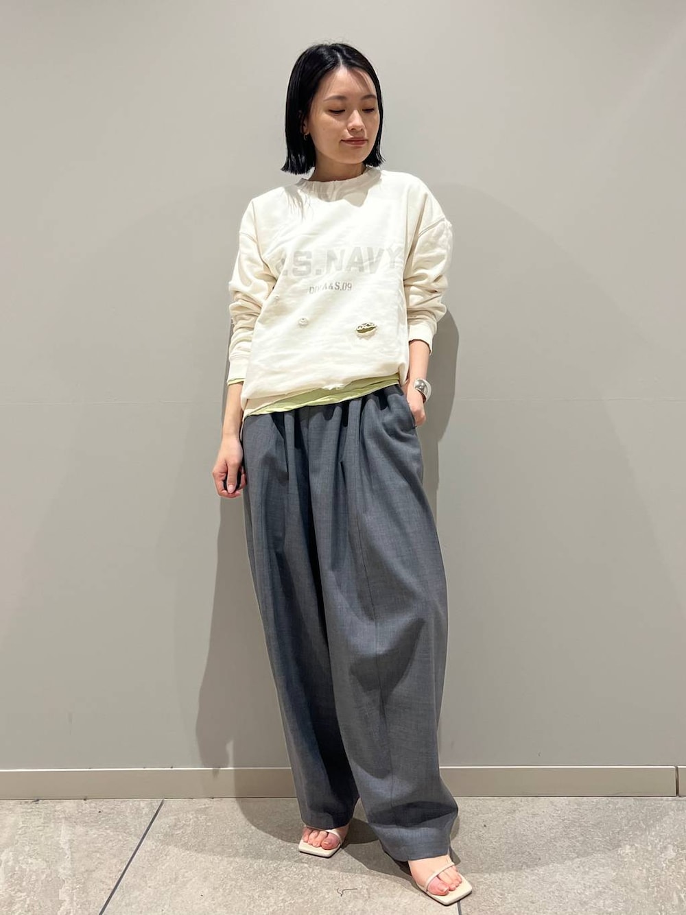 イエロー系のTシャツ/カットソー、グレー系のその他パンツ、シルバー系のバングル/リストバンドを着用したレディースの冬コーディネートの1枚目の写真