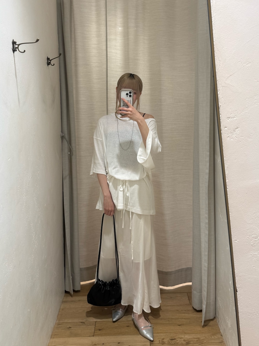 ホワイト系のTシャツ/カットソー、ホワイト系のスカート、ブラック系のショルダーバッグを着用したレディースの春コーディネートの1枚目の写真