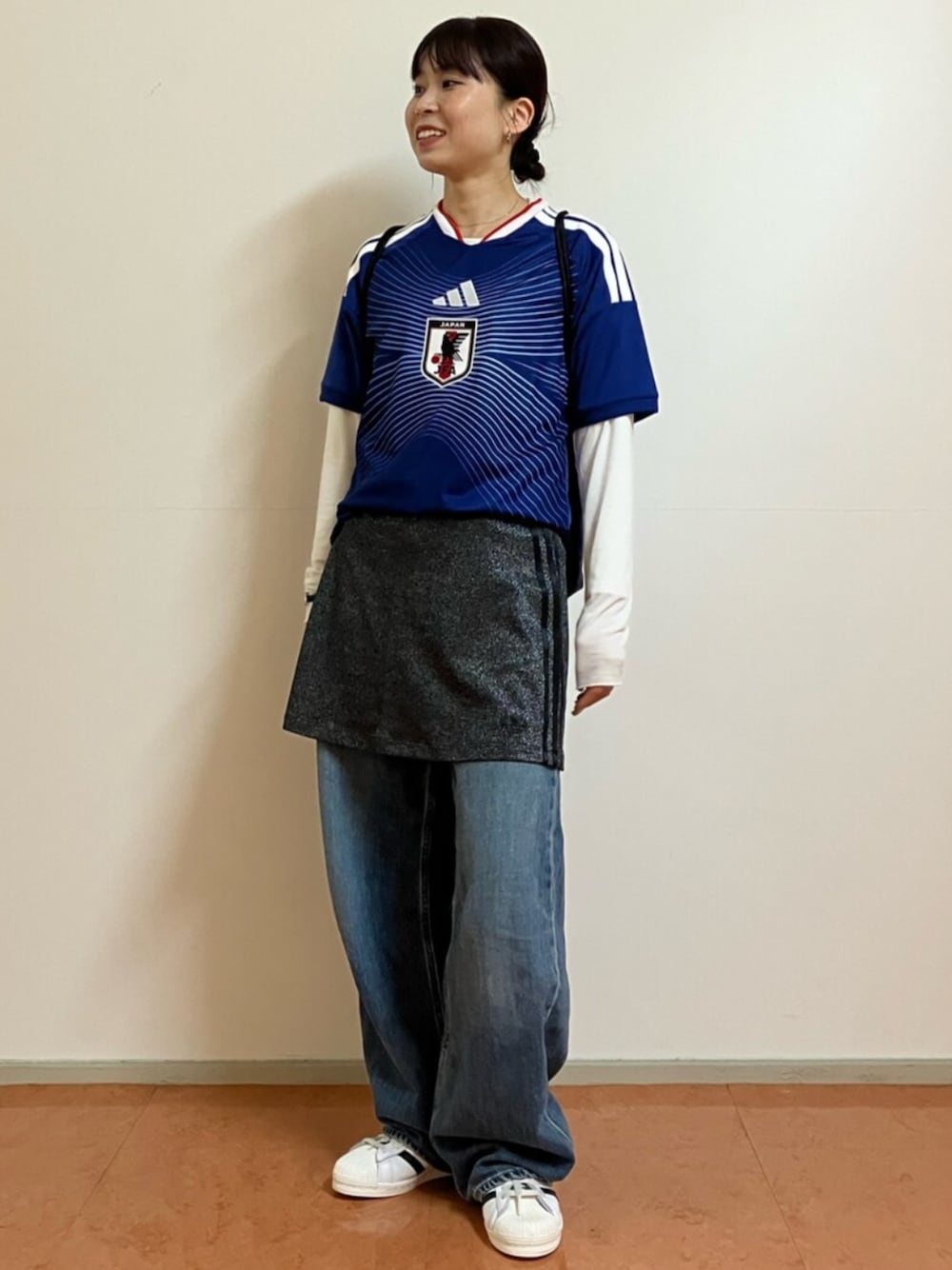 ブルー系のTシャツ/カットソー、ブラック系のスカートを着用したレディースの秋コーディネートの1枚目の写真