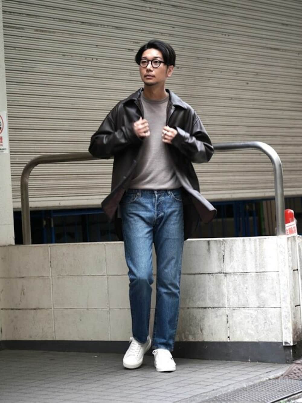 ブラウン系のブルゾン、ホワイト系のニット/セーター、ブルー系のデニムパンツを着用したメンズの秋コーディネートの1枚目の写真