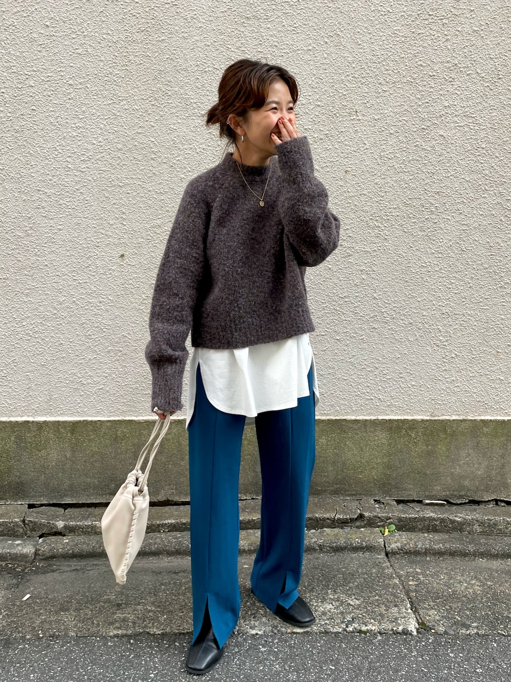 ブラック系のブーツ、ブルー系のその他パンツ、ホワイト系のショルダーバッグを着用したレディースの秋コーディネートの1枚目の写真