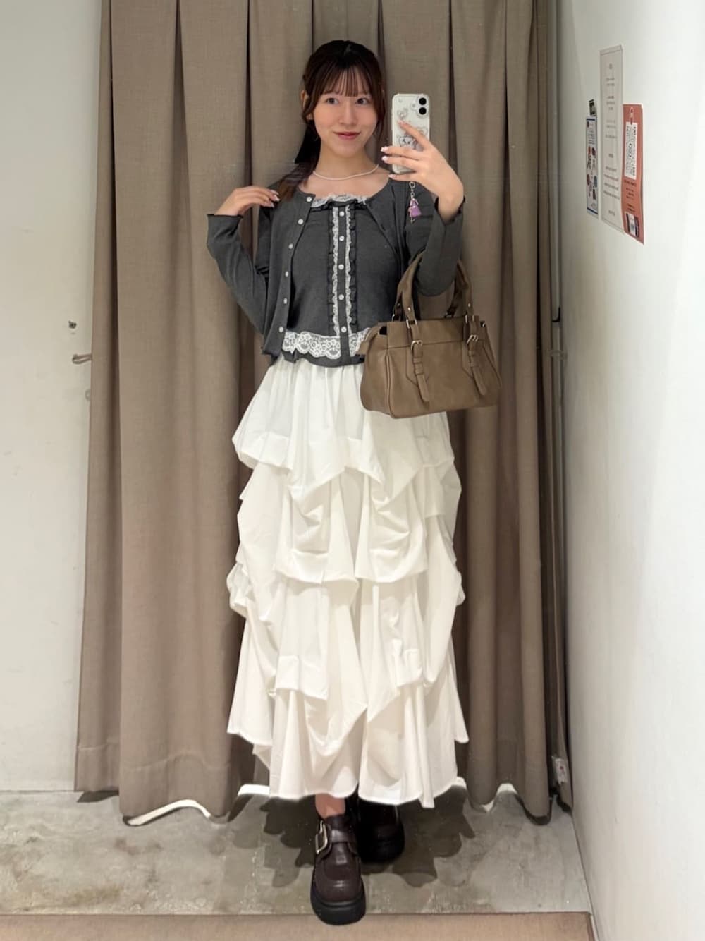 グレー系のTシャツ/カットソー、ブラウン系のショルダーバッグ、ホワイト系のスカートを着用したレディースの秋コーディネートの1枚目の写真