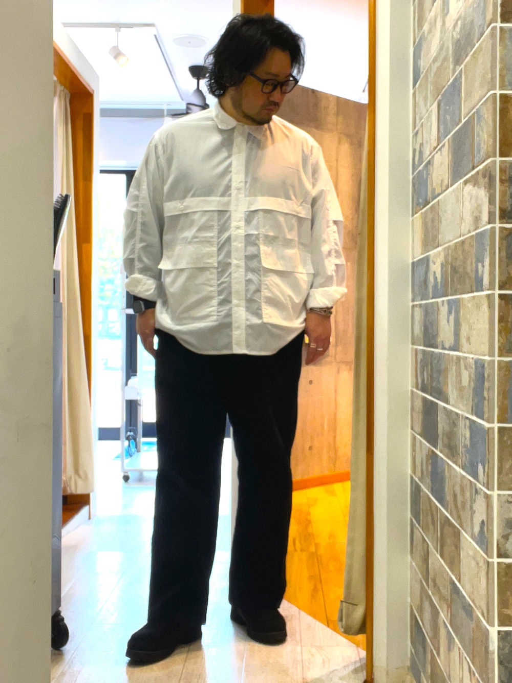 ブラック系のその他パンツ、ブラック系のモカシン/デッキシューズ、ホワイト系のシャツ/ブラウスを着用したメンズの春コーディネートの1枚目の写真