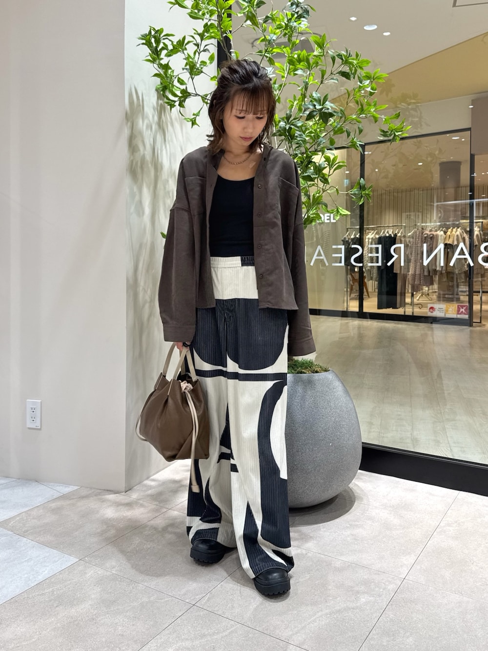 ブラウン系のシャツ/ブラウス、ブラウン系のショルダーバッグを着用したレディースの秋コーディネートの1枚目の写真