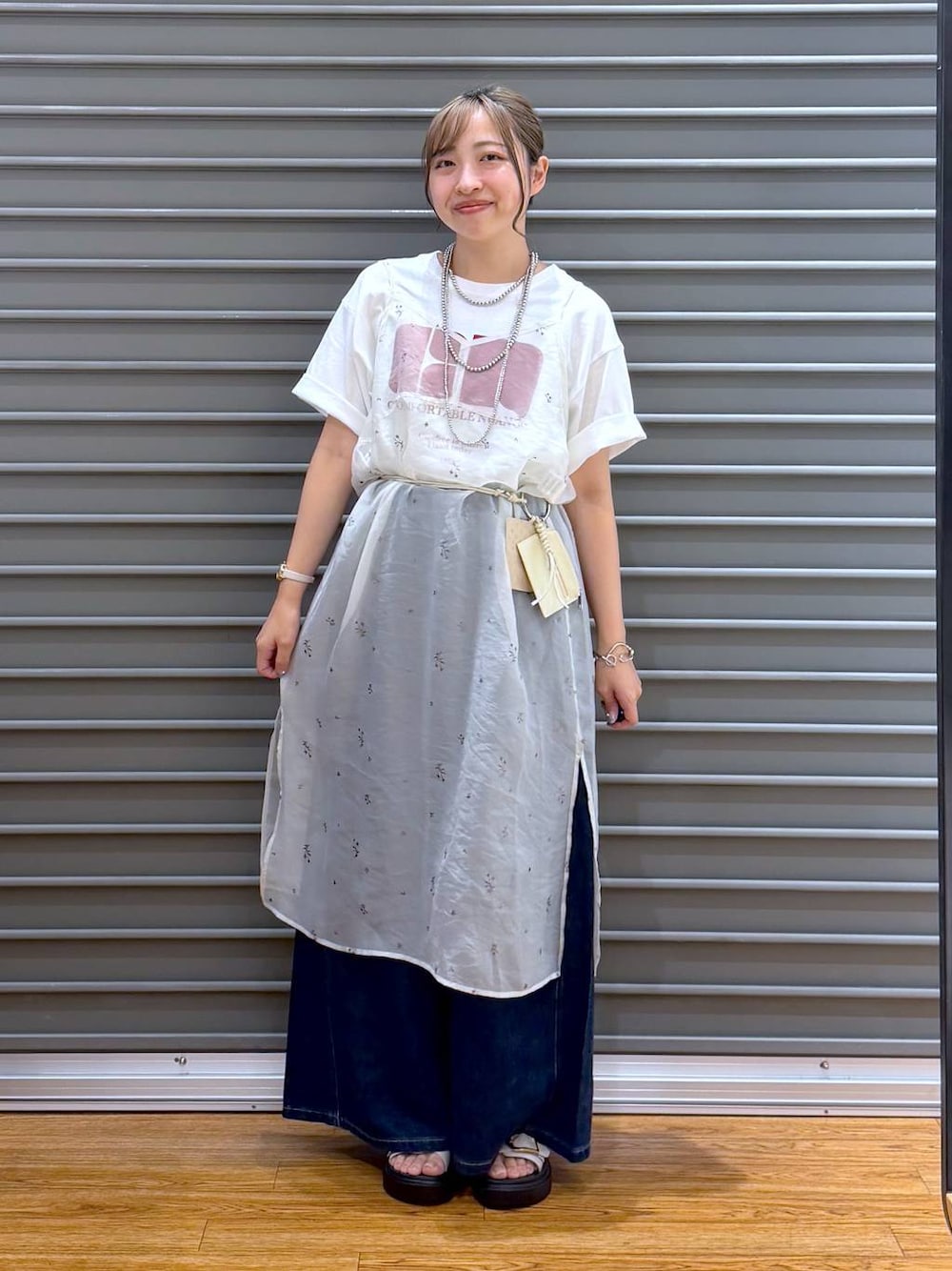 ホワイト系のワンピース、ホワイト系のTシャツ/カットソー、ホワイト系のサンダルを着用したレディースの夏コーディネートの1枚目の写真