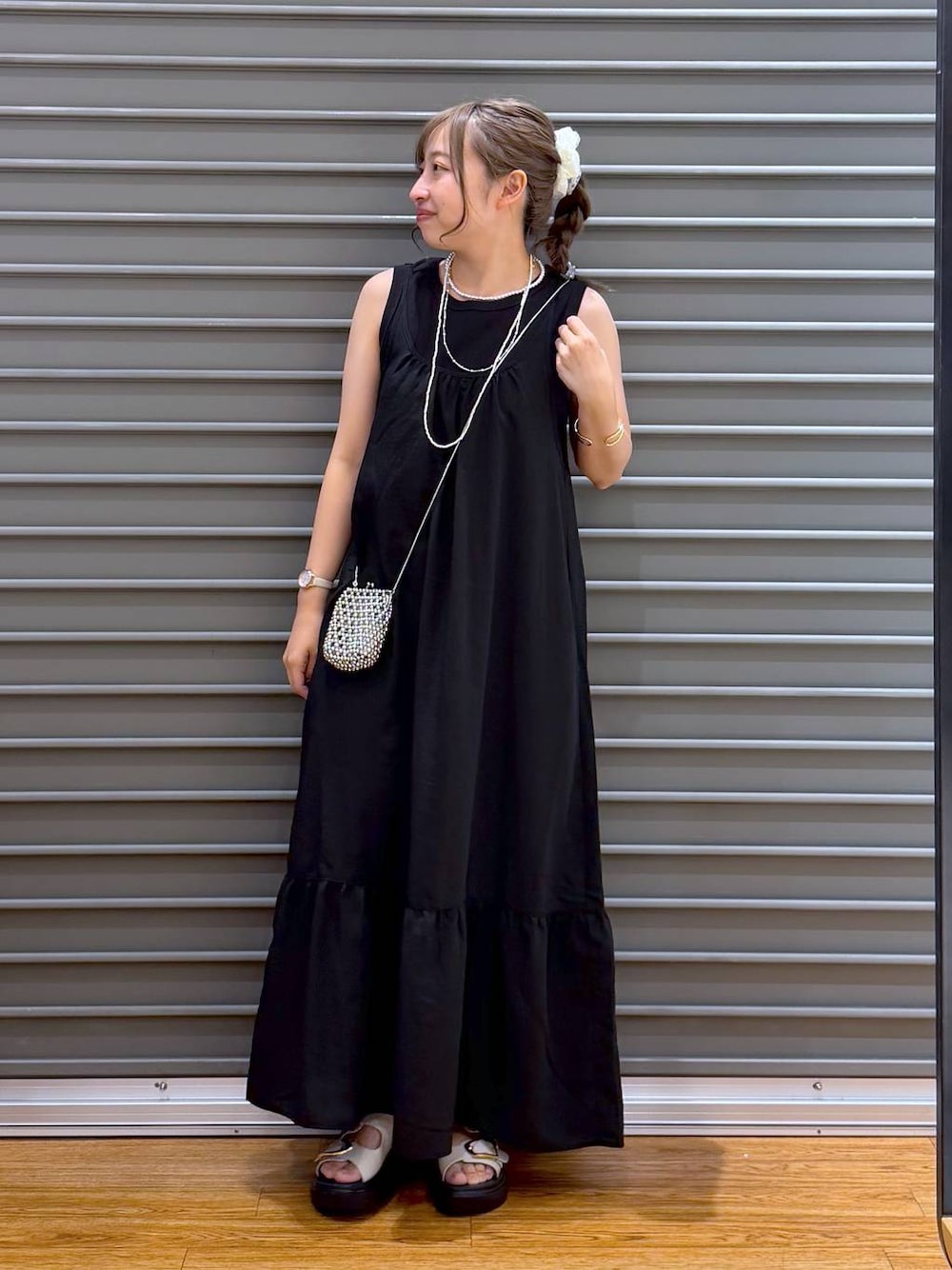 ブラック系のワンピース、ホワイト系のサンダル、ブラック系のタンクトップを着用したレディースの夏コーディネートの1枚目の写真