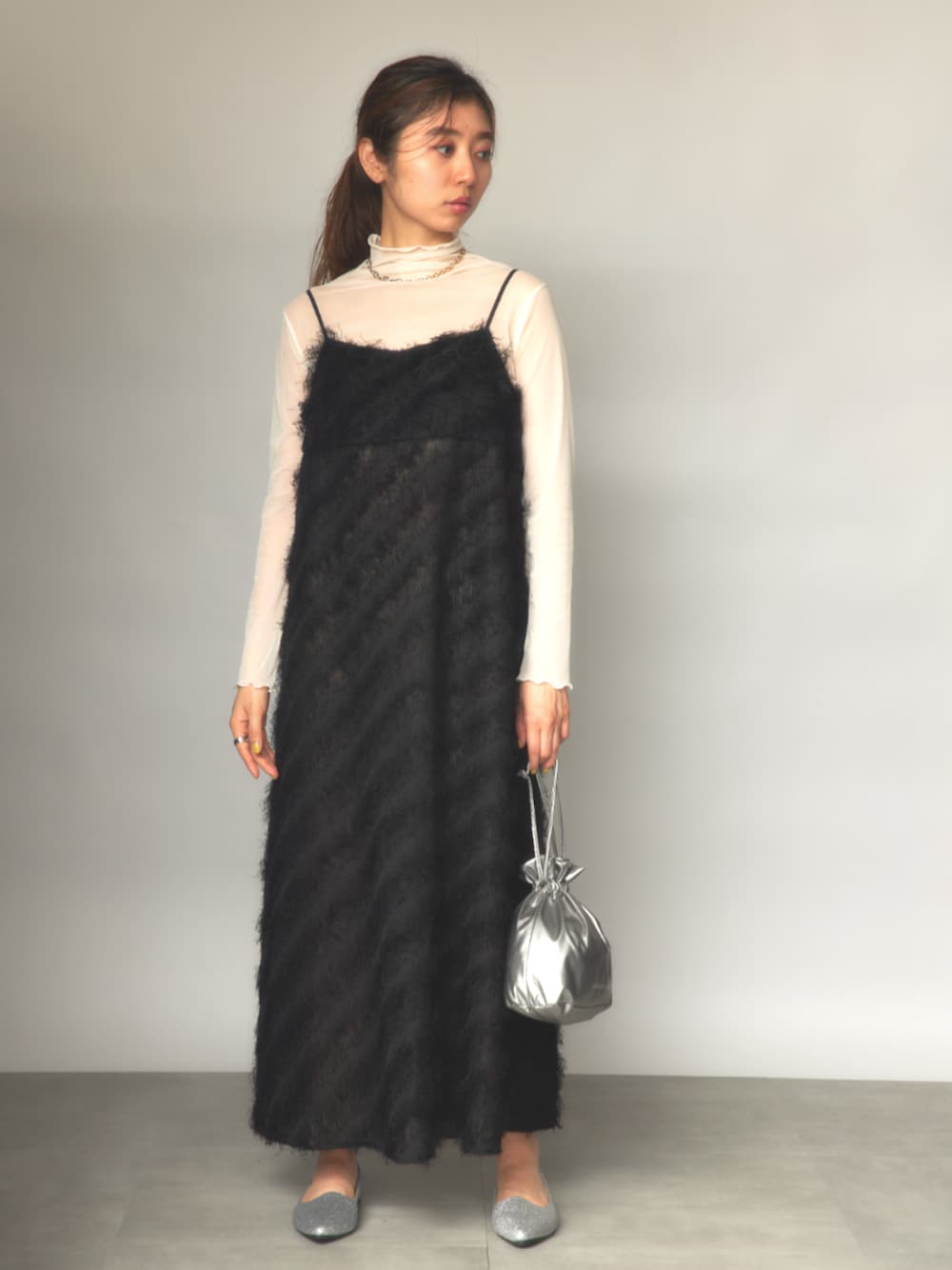ホワイト系のTシャツ/カットソー、ブラック系のワンピース、シルバー系のショルダーバッグを着用したレディースの冬コーディネートの1枚目の写真