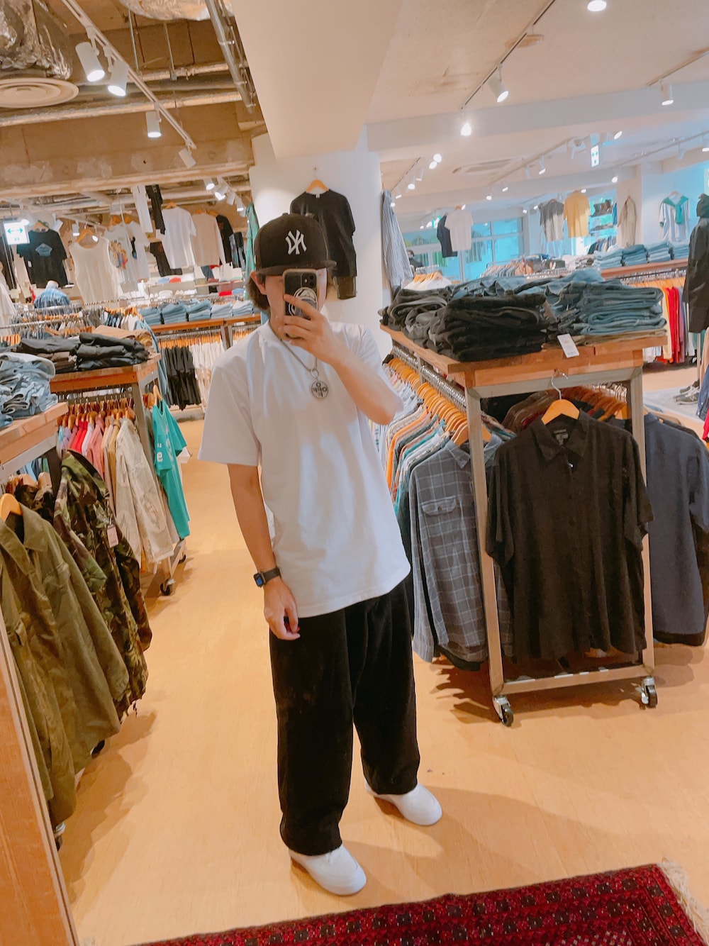 ホワイト系のTシャツ/カットソー、ブラック系のデニムパンツ、ホワイト系のスニーカーを着用したメンズの夏コーディネートの1枚目の写真