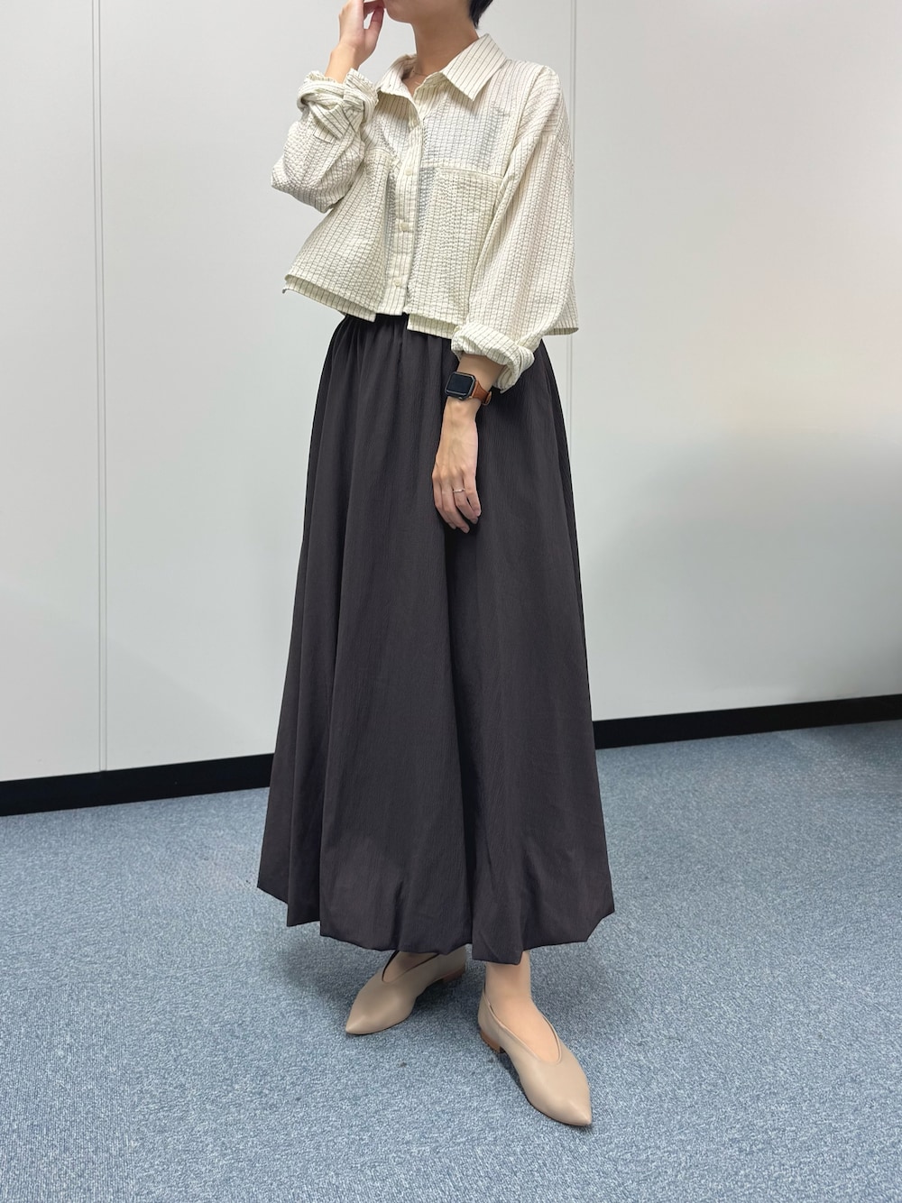 ホワイト系のシャツ/ブラウス、ブラウン系のスカート、ベージュ系のパンプスを着用したレディースの秋コーディネートの1枚目の写真