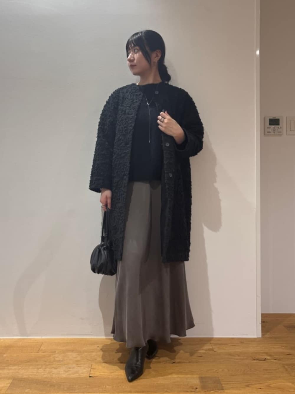 グリーン系のスカート、ブラック系のその他アウターを着用したレディースの夏コーディネートの1枚目の写真