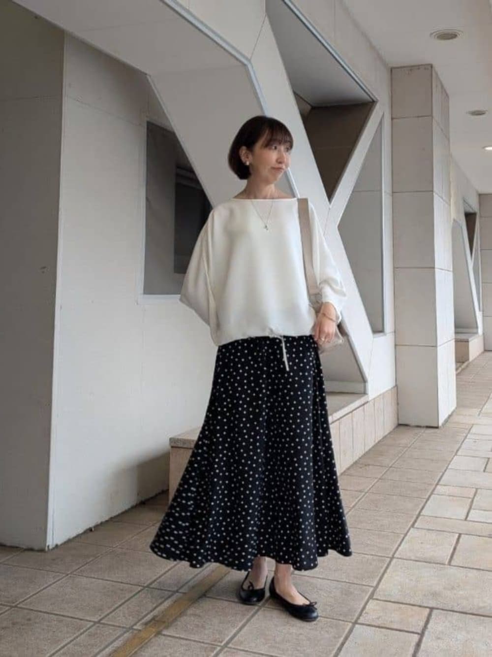 ブラック系のスカート、ホワイト系のシャツ/ブラウスを着用したレディースの冬コーディネートの1枚目の写真