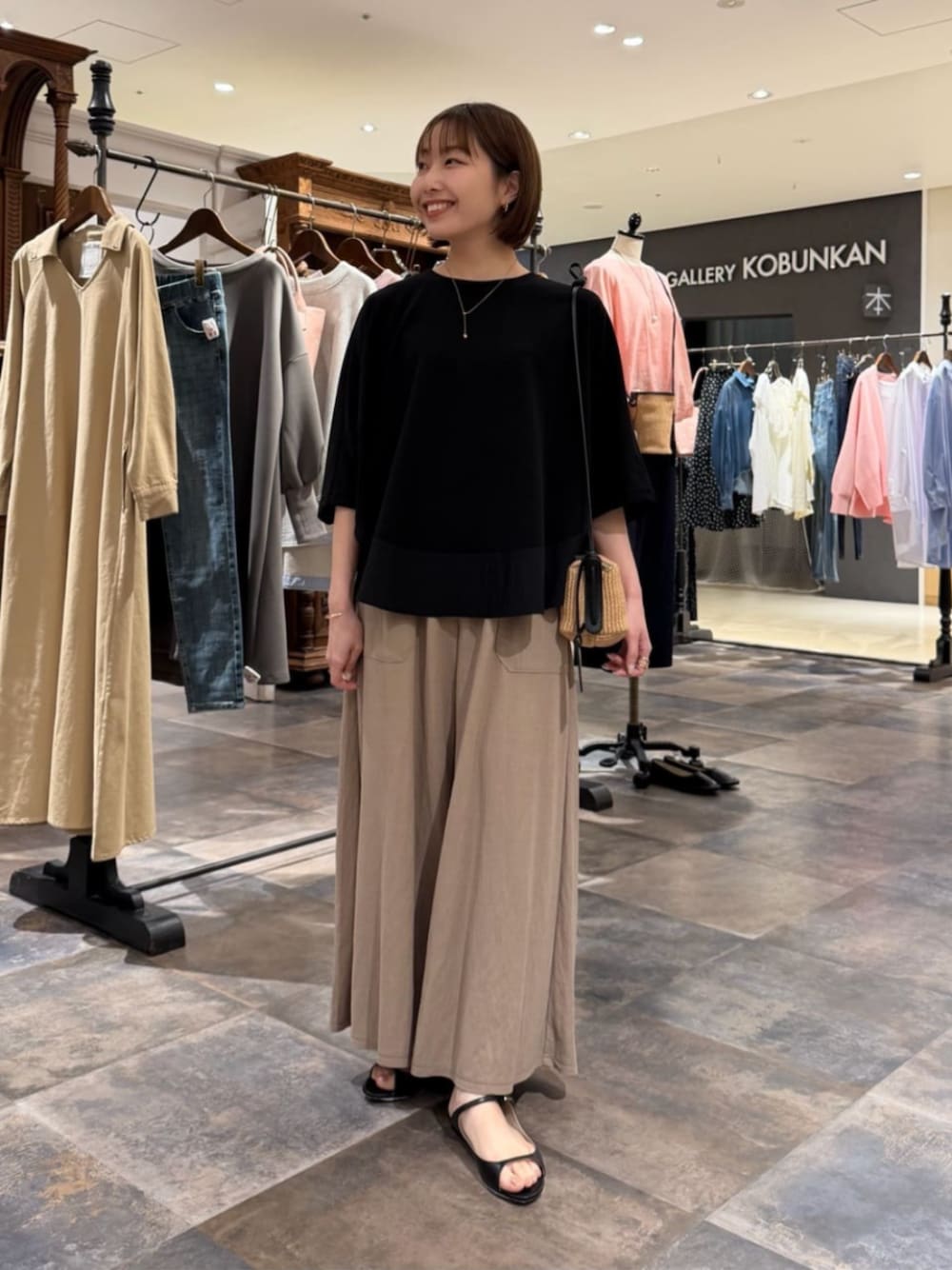 ベージュ系のその他パンツ、ブラック系のTシャツ/カットソーを着用したレディースの春コーディネートの1枚目の写真