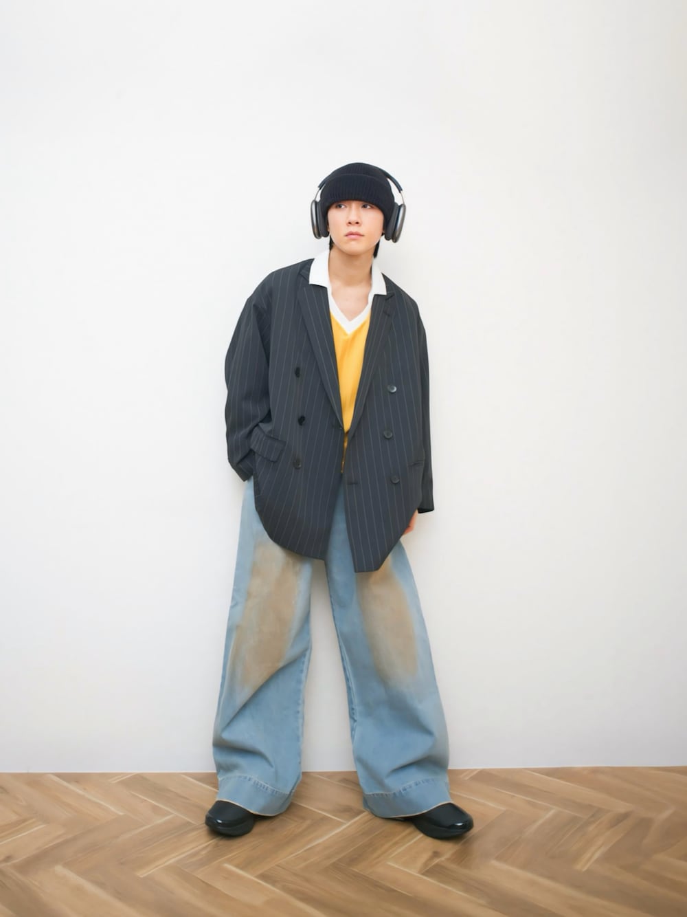 イエロー系のTシャツ/カットソー、ブラック系のテーラードジャケット、ブルー系のデニムパンツを着用したメンズの春コーディネートの1枚目の写真