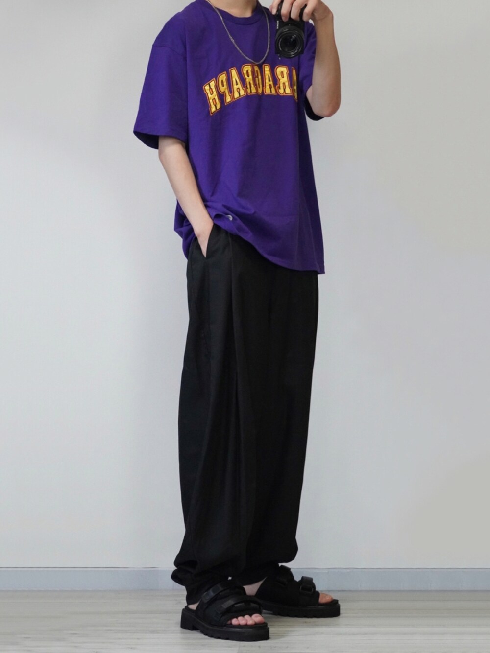 パープル系のTシャツ/カットソー、ブラック系のその他パンツ、ブラック系のサンダルを着用したメンズの夏コーディネートの1枚目の写真