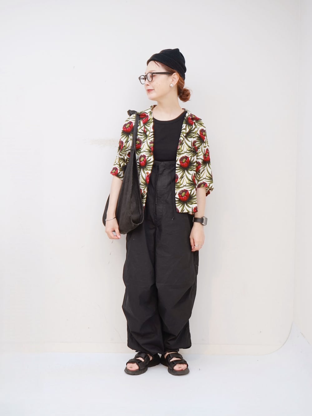 ブラック系のカーゴパンツ、ブラック系のショルダーバッグ、ブラック系のサンダルを着用したレディースの夏コーディネートの1枚目の写真