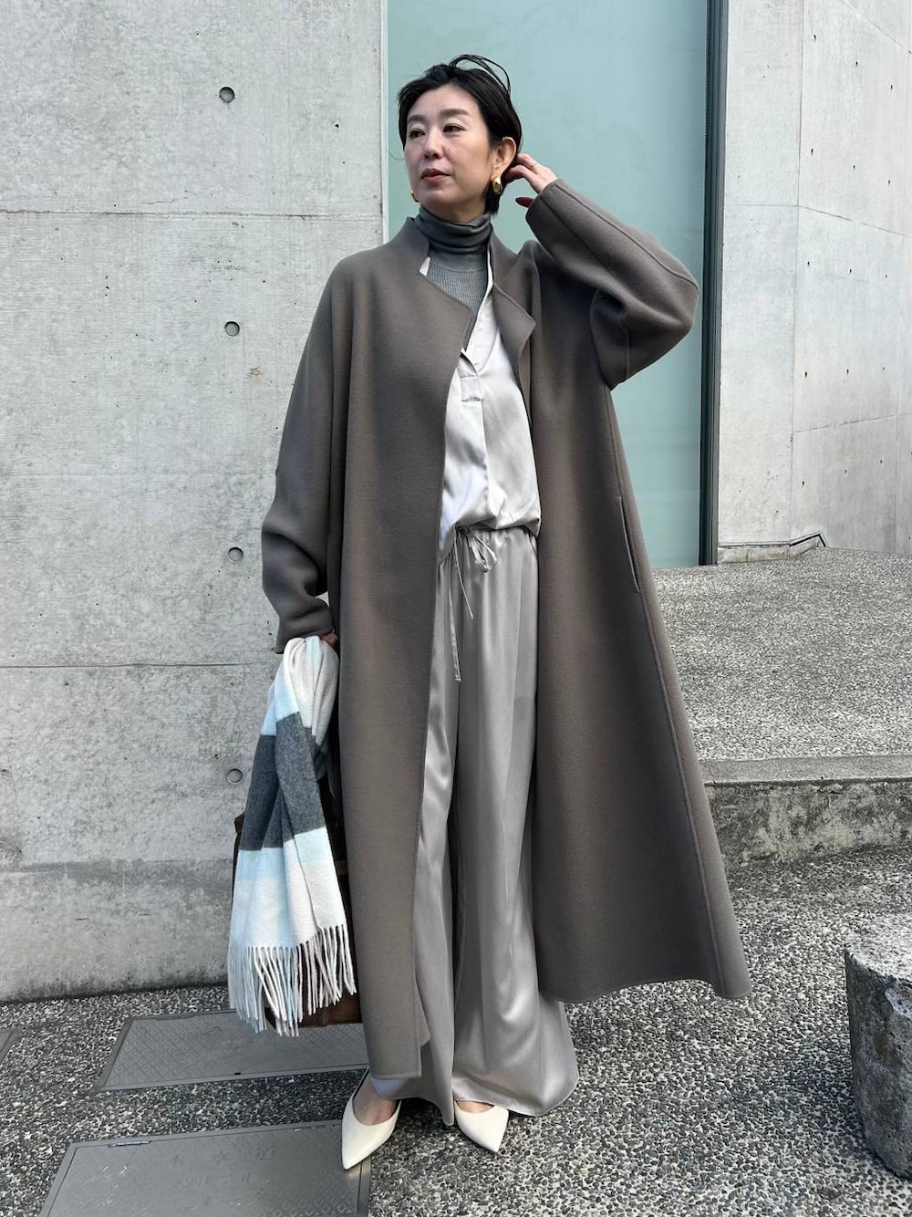 グレー系のその他パンツ、グレー系のニット/セーター、ブラウン系のノーカラーコートを着用したレディースの秋コーディネートの1枚目の写真