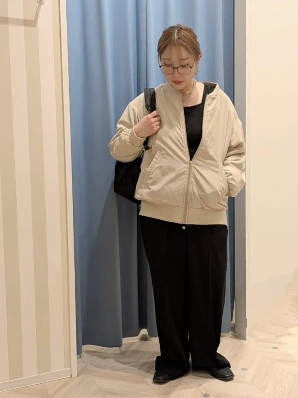 ベージュ系のブルゾン、ブラック系のその他パンツ、ブラック系のバックパック/リュックを着用したレディースの冬コーディネートの1枚目の写真