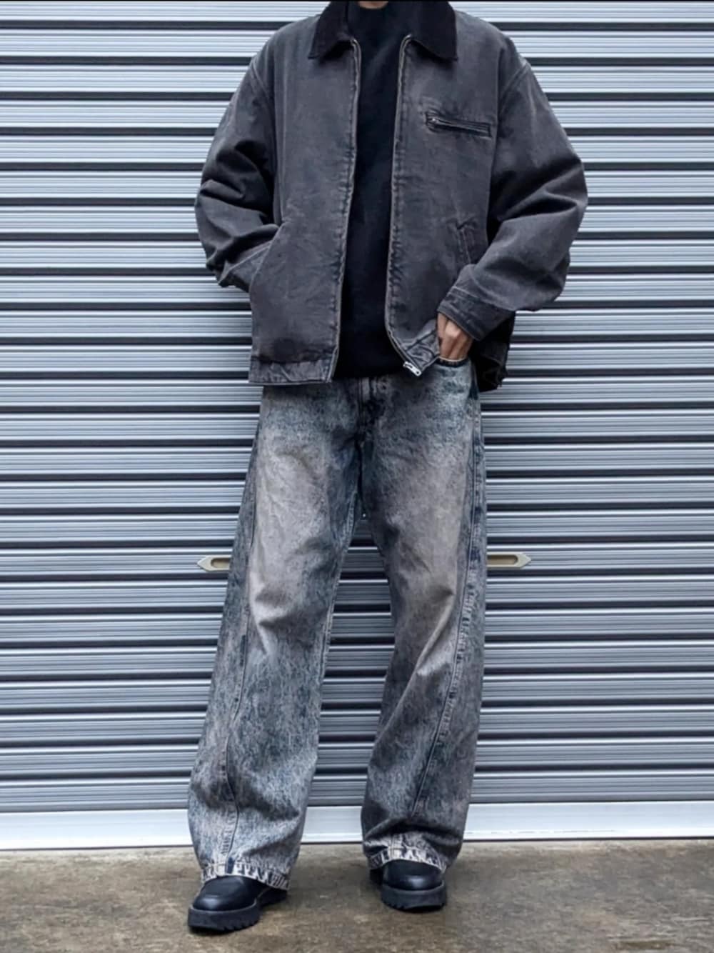 ブラック系のカバーオール、ブルー系のデニムパンツ、ブラック系のドレスシューズを着用したメンズの秋コーディネートの1枚目の写真