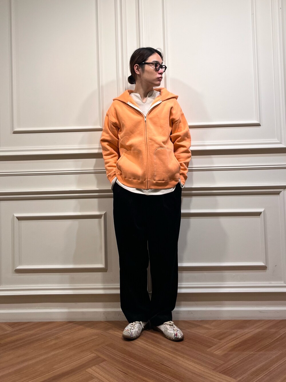 ホワイト系のTシャツ/カットソー、オレンジ系のパーカー、イエロー系のメガネを着用したメンズの秋コーディネートの1枚目の写真